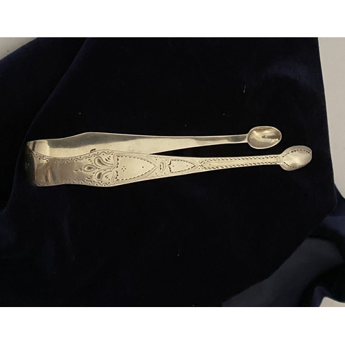 12 - A GEORGE III SILVER SUGAR TONGS, Hallmarked London c.1792, makers marks rubbed. Featuring intricate ... 