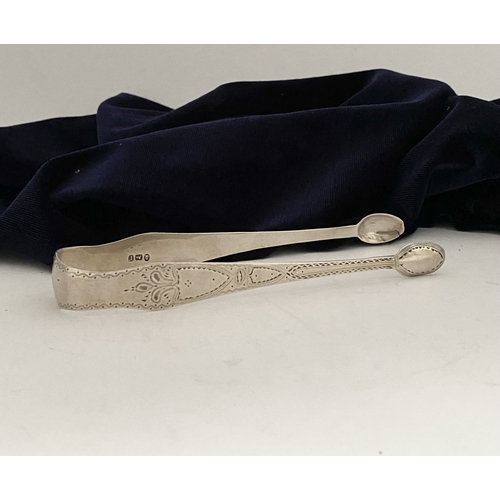 12 - A GEORGE III SILVER SUGAR TONGS, Hallmarked London c.1792, makers marks rubbed. Featuring intricate ... 