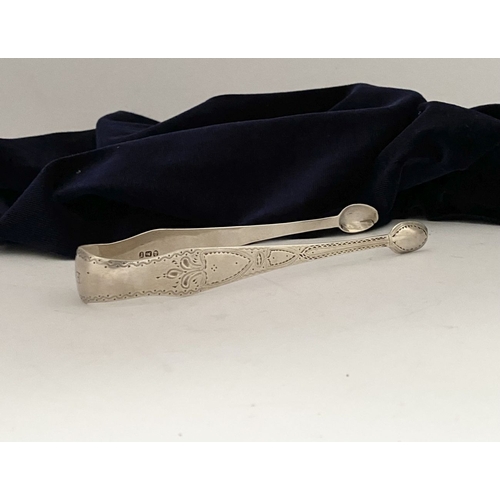 12 - A GEORGE III SILVER SUGAR TONGS, Hallmarked London c.1792, makers marks rubbed. Featuring intricate ... 