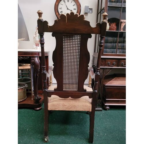 124 - A JACOBEAN REVIVAL STYLE CANE BACKED CARVED ARM CHAIR, the crest rail with beautiful carved Prince o... 