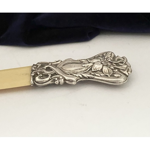 19 - AN ART NOUVEAU SILVER MOUNTED PAPER KNIFE/LETTER OPENER, c.1902. The silver mount with intricate Art... 