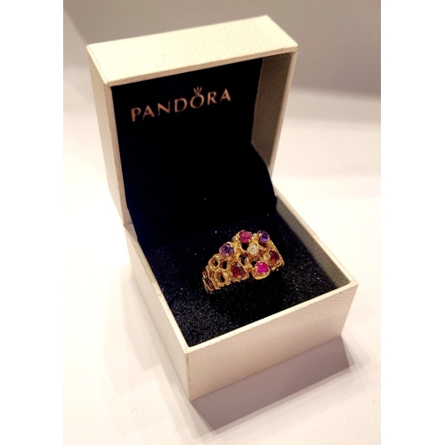 20 - AN EYE CATCHING 9CT YELLOW GOLD MULTI STONE CLUSTER / COCKTAIL RING, with pierced band & shank set w... 