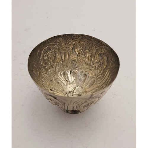 32 - AN ANTIQUE SILVER BOWL, possibly Indian, decorated with a floral panel design to the outside, raised... 