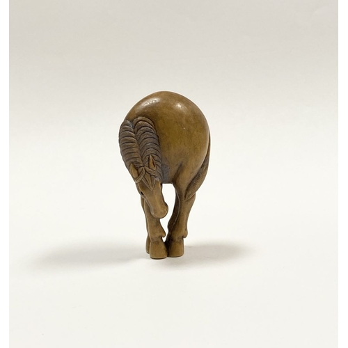 35 - AN ANTIQUE HAND CARVED JAPANESE BOXWOOD NETSUKE, in the form of a horse, signed to reverse on inlaid... 