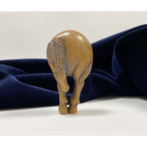 35 - AN ANTIQUE HAND CARVED JAPANESE BOXWOOD NETSUKE, in the form of a horse, signed to reverse on inlaid... 