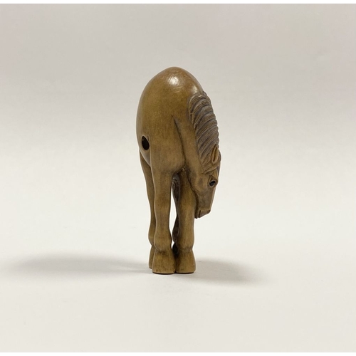 35 - AN ANTIQUE HAND CARVED JAPANESE BOXWOOD NETSUKE, in the form of a horse, signed to reverse on inlaid... 