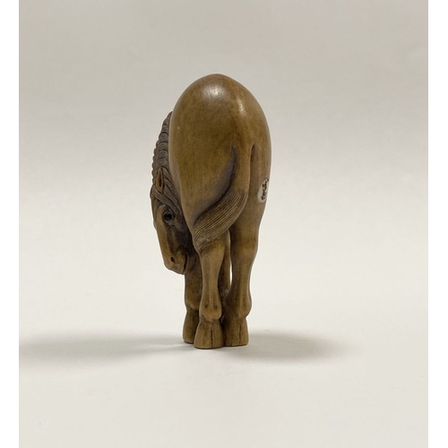 35 - AN ANTIQUE HAND CARVED JAPANESE BOXWOOD NETSUKE, in the form of a horse, signed to reverse on inlaid... 