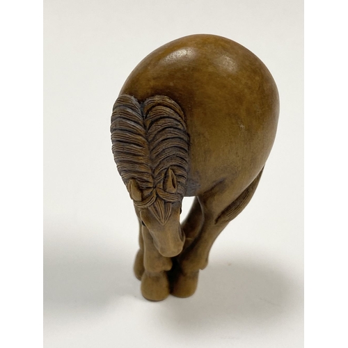 35 - AN ANTIQUE HAND CARVED JAPANESE BOXWOOD NETSUKE, in the form of a horse, signed to reverse on inlaid... 