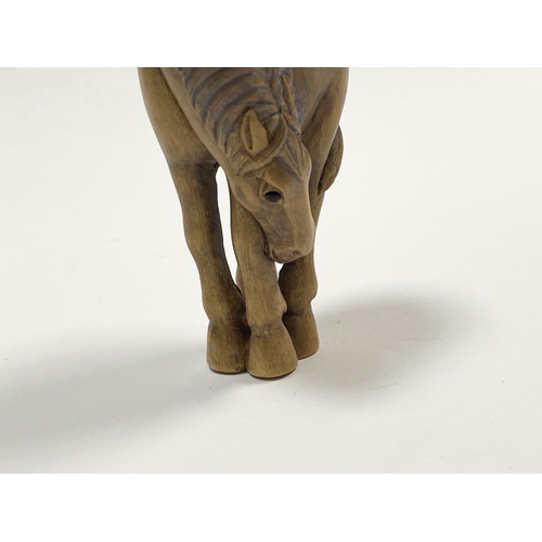 35 - AN ANTIQUE HAND CARVED JAPANESE BOXWOOD NETSUKE, in the form of a horse, signed to reverse on inlaid... 