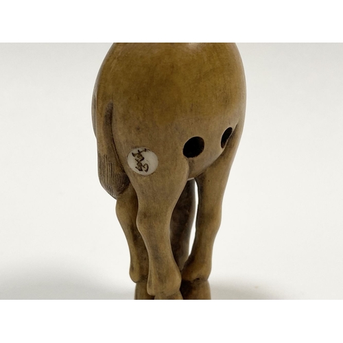 35 - AN ANTIQUE HAND CARVED JAPANESE BOXWOOD NETSUKE, in the form of a horse, signed to reverse on inlaid... 