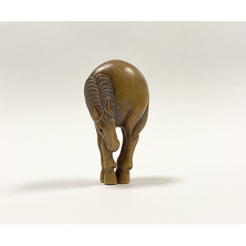 35 - AN ANTIQUE HAND CARVED JAPANESE BOXWOOD NETSUKE, in the form of a horse, signed to reverse on inlaid... 