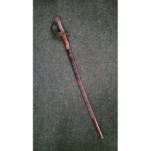 43 - AN EAST INDIA COMPANY NAVAL PIPE-BACK SWORD, in a leather scabbard. The blade is etched with the Hon... 