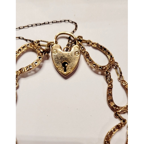 49 - A GOOD QUALITY VINTAGE 9CT YELLOW GOLD HORSESHOE LINK BRACELET, with heart shaped locket clasp. Link... 