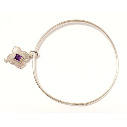 54 - A WRIGHT & TEAGUE STERLING SILVER & AMETHYST CHARM BANGLE, a sterling silver bangle with silver char... 