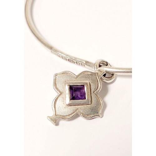 54 - A WRIGHT & TEAGUE STERLING SILVER & AMETHYST CHARM BANGLE, a sterling silver bangle with silver char... 