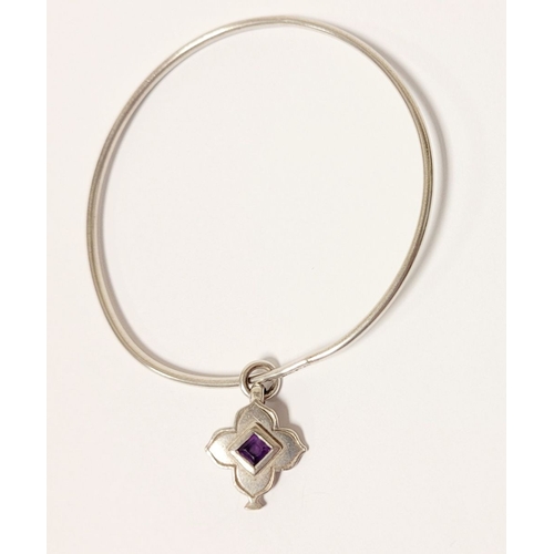 54 - A WRIGHT & TEAGUE STERLING SILVER & AMETHYST CHARM BANGLE, a sterling silver bangle with silver char... 