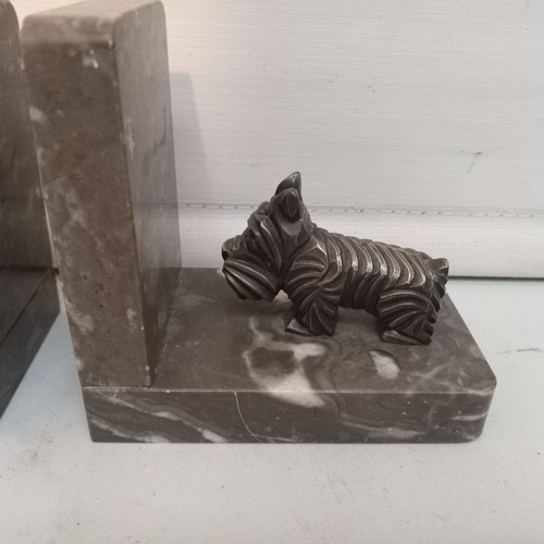 59 - A LOVELY PAIR OF ART DECO MANTELPIECE ORNAMENTS OR BOOKENDS modelled as Scottie dogs on marble bases... 