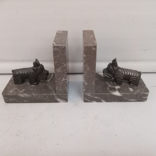 59 - A LOVELY PAIR OF ART DECO MANTELPIECE ORNAMENTS OR BOOKENDS modelled as Scottie dogs on marble bases... 