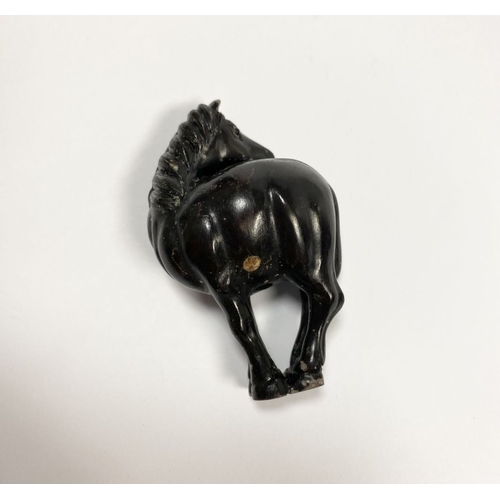 8 - AN ANTIQUE HAND CARVED JAPANESE WOOD NETSUKE, in the form of a horse, signed to reverse on inlaid bo... 