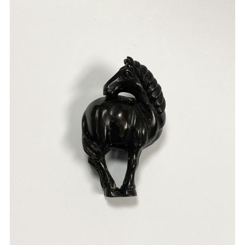 8 - AN ANTIQUE HAND CARVED JAPANESE WOOD NETSUKE, in the form of a horse, signed to reverse on inlaid bo... 