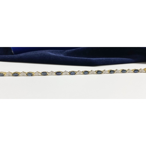 10 - A FANTASTIC 14CT YELLOW GOLD SAPPHIRE & DIAMOND TENNIS BRACELET, featuring thirteen marquise cut sap... 