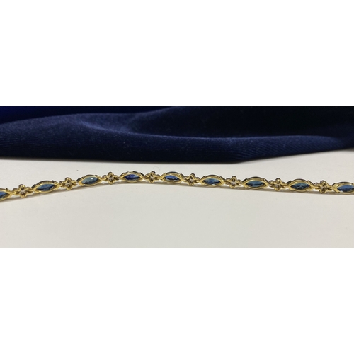 10 - A FANTASTIC 14CT YELLOW GOLD SAPPHIRE & DIAMOND TENNIS BRACELET, featuring thirteen marquise cut sap... 