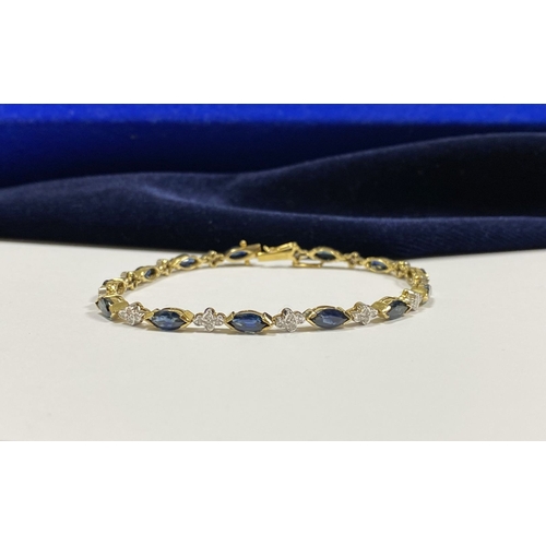 10 - A FANTASTIC 14CT YELLOW GOLD SAPPHIRE & DIAMOND TENNIS BRACELET, featuring thirteen marquise cut sap... 