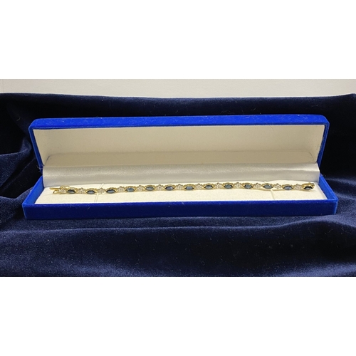 10 - A FANTASTIC 14CT YELLOW GOLD SAPPHIRE & DIAMOND TENNIS BRACELET, featuring thirteen marquise cut sap... 