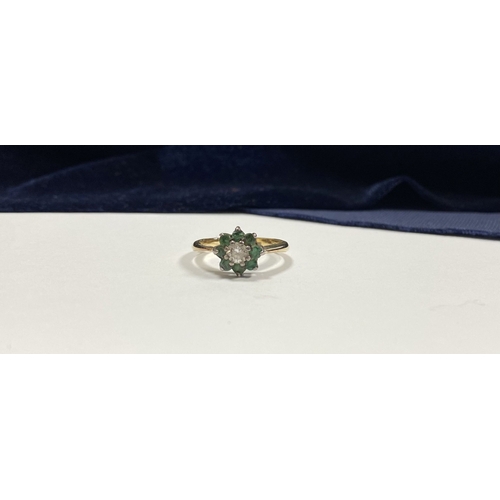 108 - A GEMSET GOLD & SILVER FLOWER RING, with central round cut clear gemstone surrounded by eight round ... 