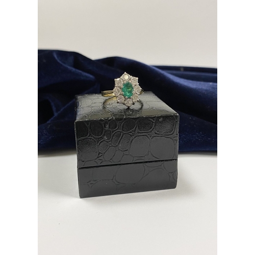 12 - AN 18CT YELLOW GOLD EMERALD & DIAMOND CLUSTER RING, with central oval cut vibrant emerald in claw se... 