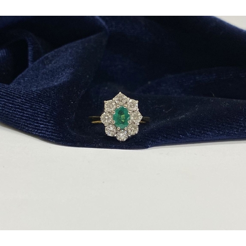 12 - AN 18CT YELLOW GOLD EMERALD & DIAMOND CLUSTER RING, with central oval cut vibrant emerald in claw se... 