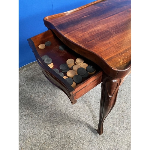 130 - AN EXCELLENT ROSEWOOD COMBINATION GAMES TABLE, serpentine shaped, the top can be overturned to revea... 