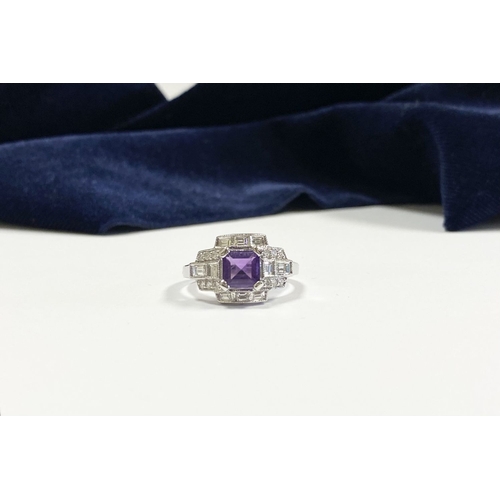 132 - AN 18CT WHITE GOLD AMETHYST & DIAMOND RING, the central amethyst is set in a four prong claw setting... 