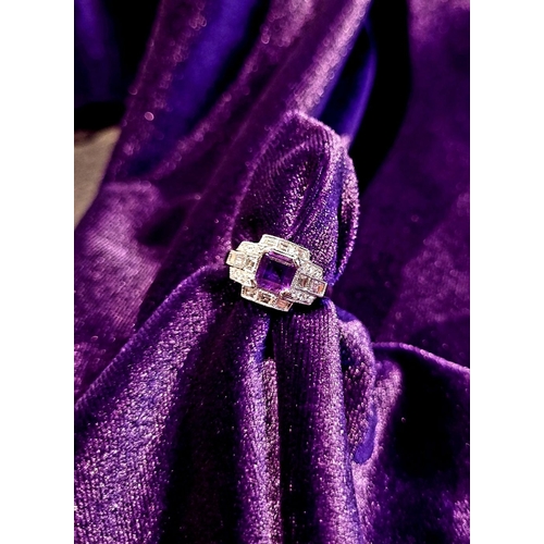 132 - AN 18CT WHITE GOLD AMETHYST & DIAMOND RING, the central amethyst is set in a four prong claw setting... 