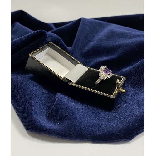 132 - AN 18CT WHITE GOLD AMETHYST & DIAMOND RING, the central amethyst is set in a four prong claw setting... 