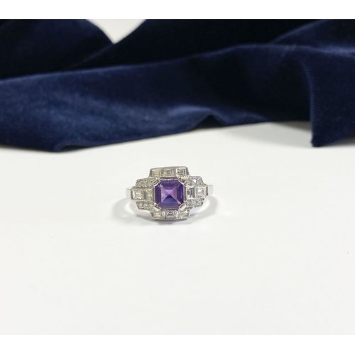 132 - AN 18CT WHITE GOLD AMETHYST & DIAMOND RING, the central amethyst is set in a four prong claw setting... 