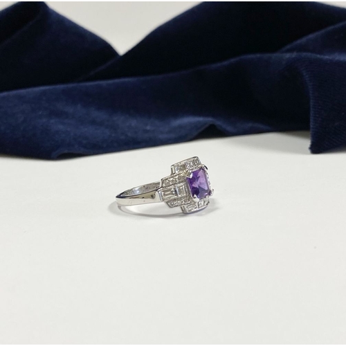 132 - AN 18CT WHITE GOLD AMETHYST & DIAMOND RING, the central amethyst is set in a four prong claw setting... 