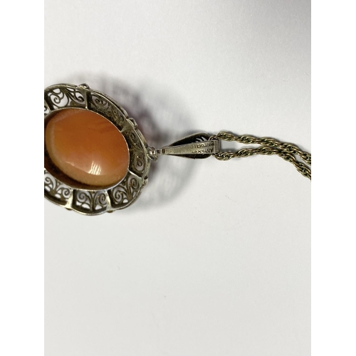 134 - A LOVELY SILVER FILIGREE CAMEO PENDANT ON GOLD NECKLACE, the finely carved oval cameo is bezel set w... 