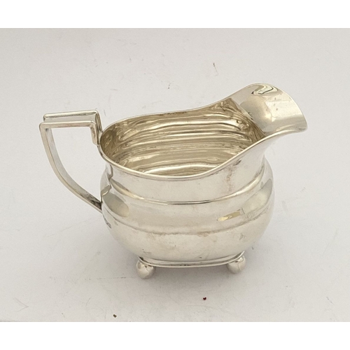 135 - A GEORGE VI SILVER SUGAR BOWL AND MILK JUG, both by EJE Sheffield, c.1941. Of matching design, raise... 