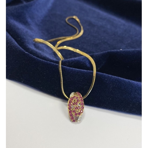 142 - A BEAUTIFUL 9CT YELLOW GOLD DIAMOND & RUBY ENCRUSTED PENDANT NECKLACE, the lovely pendant has a scro... 