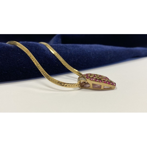 142 - A BEAUTIFUL 9CT YELLOW GOLD DIAMOND & RUBY ENCRUSTED PENDANT NECKLACE, the lovely pendant has a scro... 