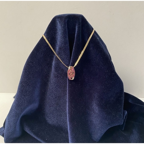 142 - A BEAUTIFUL 9CT YELLOW GOLD DIAMOND & RUBY ENCRUSTED PENDANT NECKLACE, the lovely pendant has a scro... 