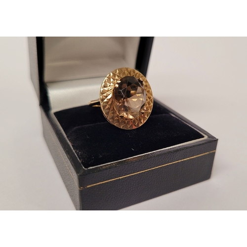 145 - A VERY FINE 9CT YELLOW GOLD SMOKY QUARTZ DRESS RING, the large oval shaped smoky quartz stone is set... 