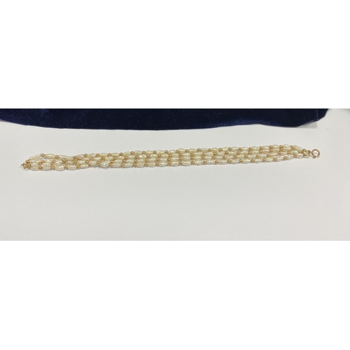 147 - A PRETTY 9CT GOLD FOUR STRAND PEARL BRACELET, each strand featuring freshwater baroque shaped pearls... 