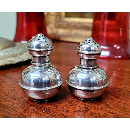 155 - A PAIR OF NEATLY SIZED SILVER SALT & PEPPER SHAKERS, each with a rounded body having a raised reed d... 