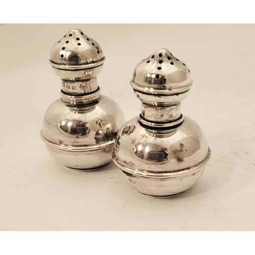 155 - A PAIR OF NEATLY SIZED SILVER SALT & PEPPER SHAKERS, each with a rounded body having a raised reed d... 