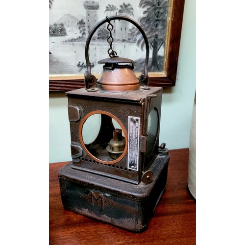 156 - AN ANTIQUE WELCH PATENT SIGNAL LAMP, with circular glass panel sides, one hinged which opens to acce... 