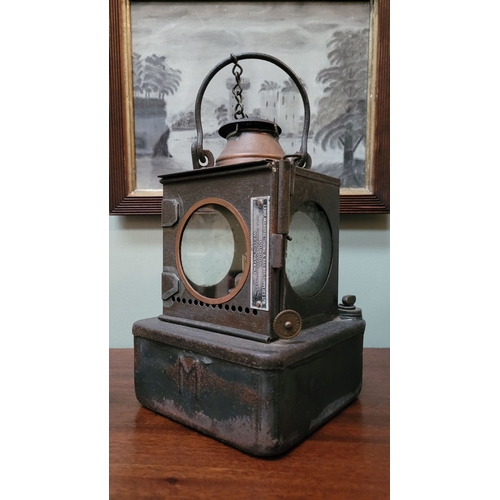 156 - AN ANTIQUE WELCH PATENT SIGNAL LAMP, with circular glass panel sides, one hinged which opens to acce... 