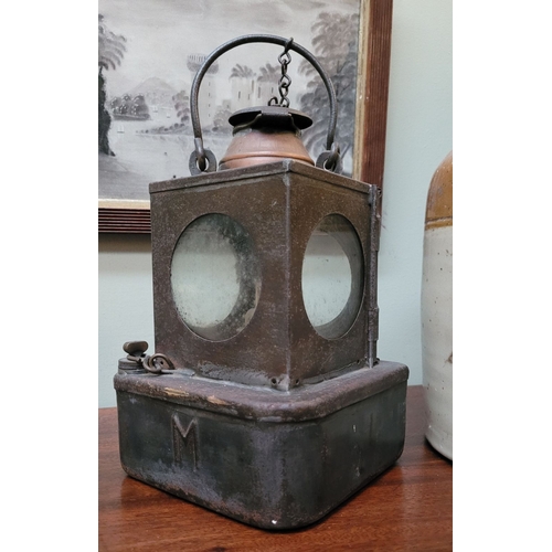 156 - AN ANTIQUE WELCH PATENT SIGNAL LAMP, with circular glass panel sides, one hinged which opens to acce... 