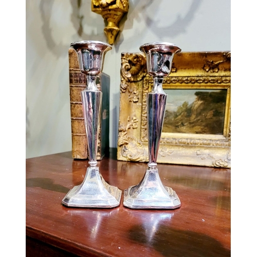 159 - TWO EARLY 20TH CENTURY ART DECO SILVER TAPERED CANDLESTICKS, with octagonal shaped base and column b... 